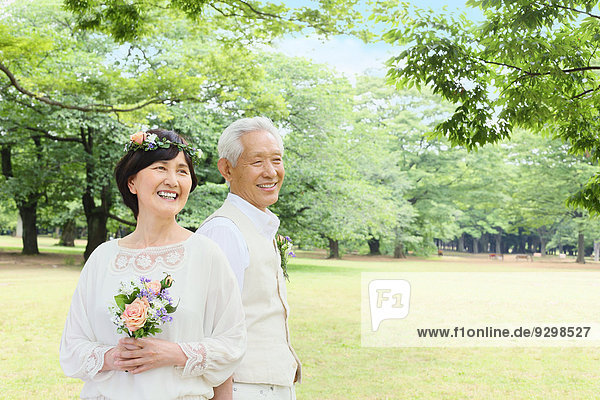 Senior adult Japanese couple in a park