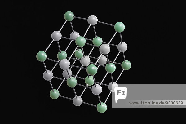 Weiße und grüne Molekularstruktur vor schwarzem Hintergrund