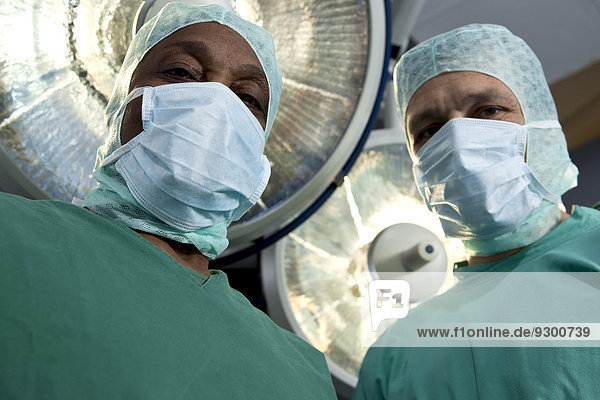 Zwei Chirurgen  die auf einen Patienten herabblicken  persönliche Perspektive