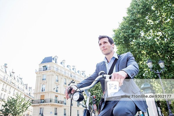 Mittlerer Erwachsener Geschäftsmann  der mit dem Fahrrad pendelt  Paris  Frankreich