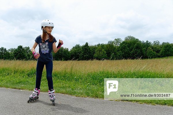 Girl rollerblading in park
