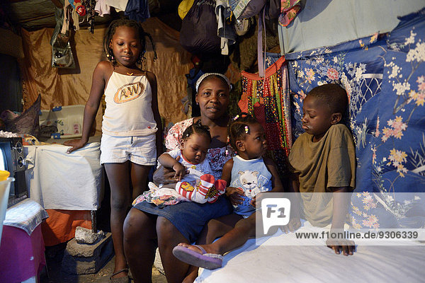 Frau mit vier Kindern in einer ärmlichen Baracke  Lager für Erdbebenflüchtlinge Camp Icare  Fort National  Port-au-Prince  Haiti