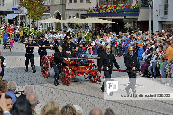Historical firemen in uniform with an engine parading at Zwetschgenfest  plum festival  Bühl  Baden  Baden-Württemberg  Germany