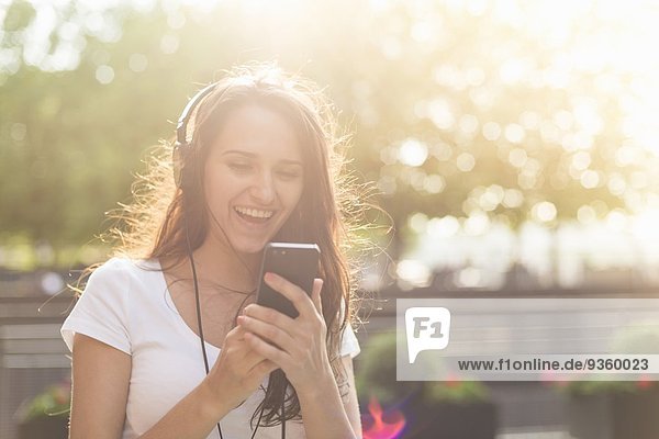 Young woman wearing headphones listening to music