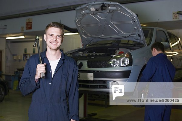 Portrait of male student mechanic in college garage