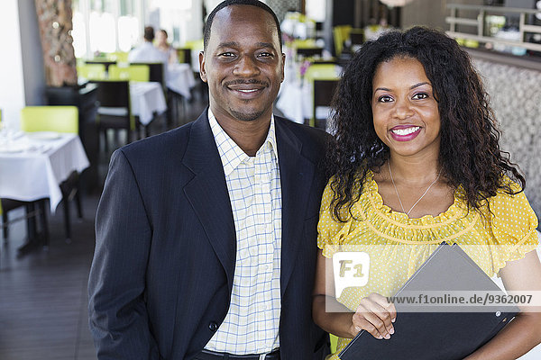 African American couple smiling in restaurant