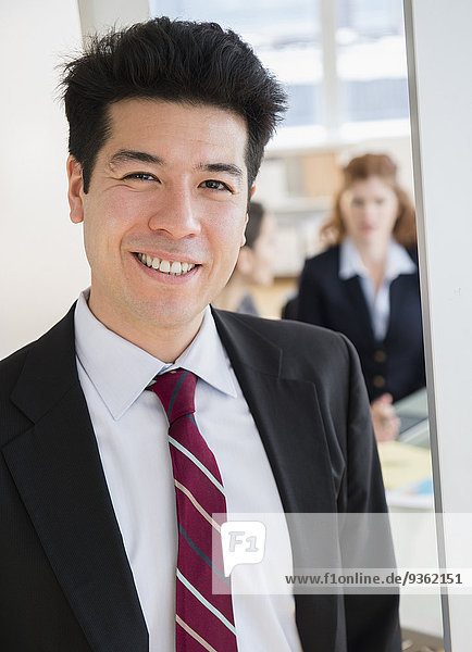 Mixed race businessman smiling in office