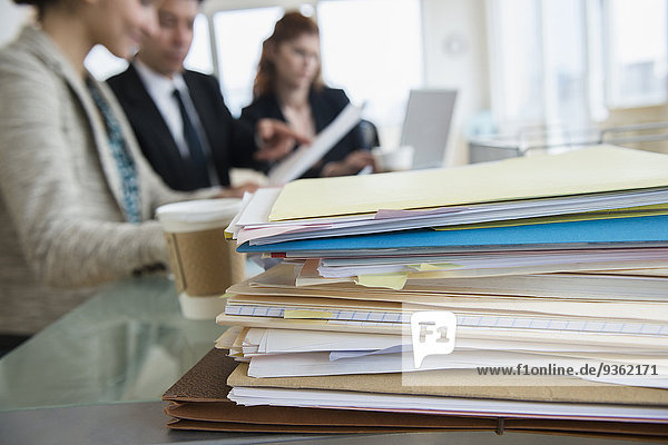 Stack of papers on desk in office