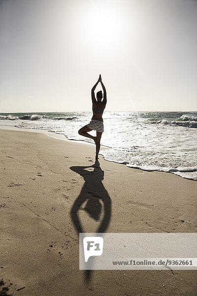 Caribbean  Barbados  Silver Sands beach  woman practicing yoga