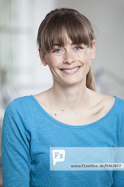 Portrait of smiling young woman in an office