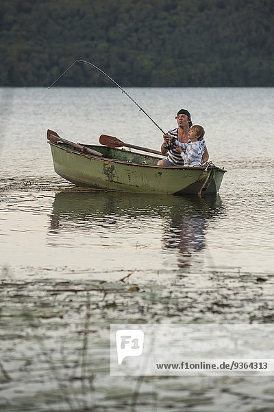 Germany  Rhineland-Palatinate  Laacher See  father and son fishing from boat