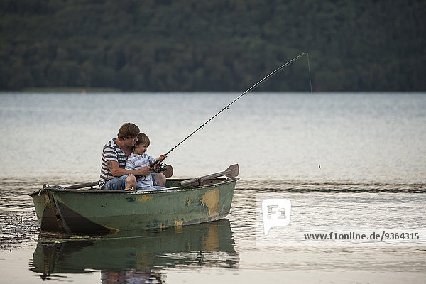 Germany  Rhineland-Palatinate  Laacher See  father and son fishing from boat