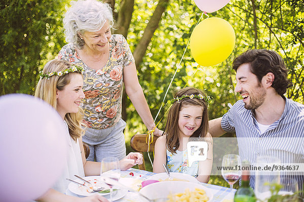 Glückliche Familie von drei Generationen auf einer Gartenparty