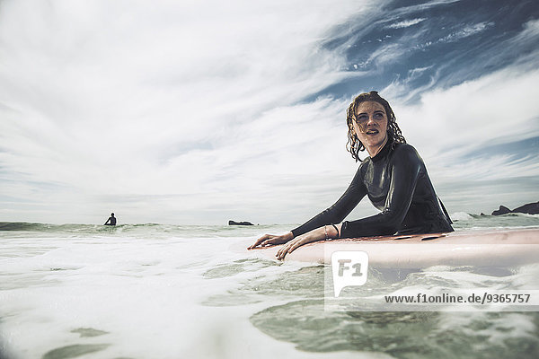 France  Bretagne  Camaret sur Mer  Teenage girl surfing at Atlantic coast