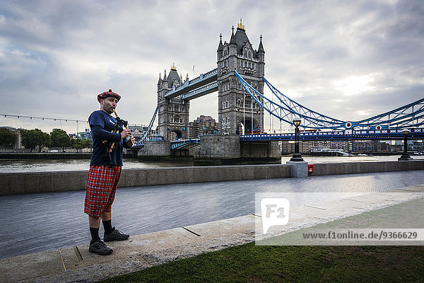 UK  London  Scottish bagpiper at Tower Bridge