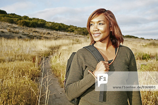Black woman hiking on rural path