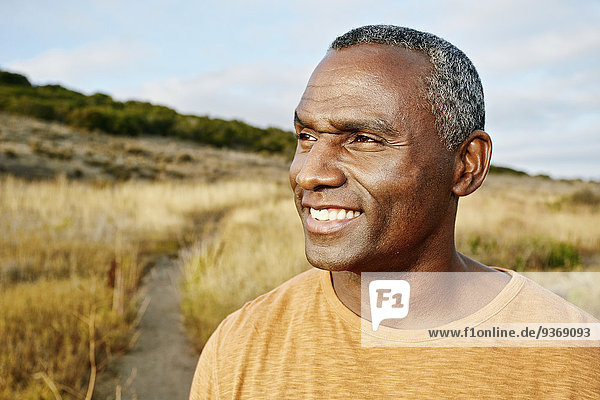 Black man standing on rural path