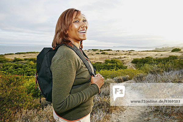 Black woman hiking on rural path