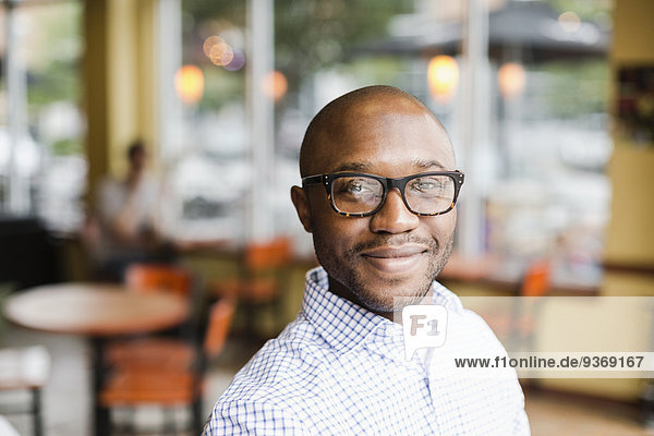 Black man smiling in coffee shop