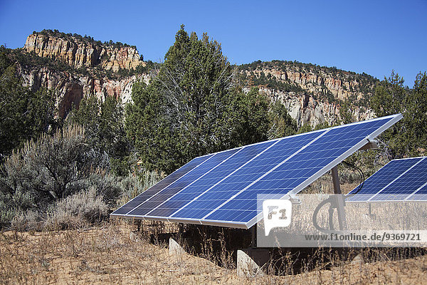 Solar panels in remote field near mountains  Zion National Park  Utah  United States