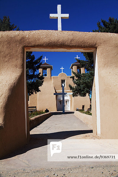 Crosses and entrance of adobe church  Ranchos de Taos  New Mexico  United States