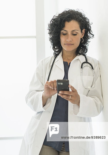Female doctor using cell phone