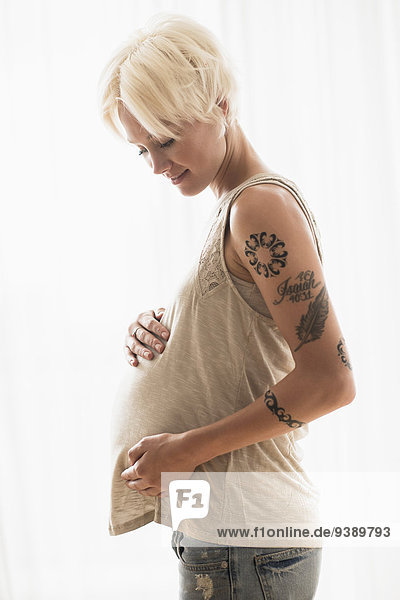 Pregnant woman with hands on stomach