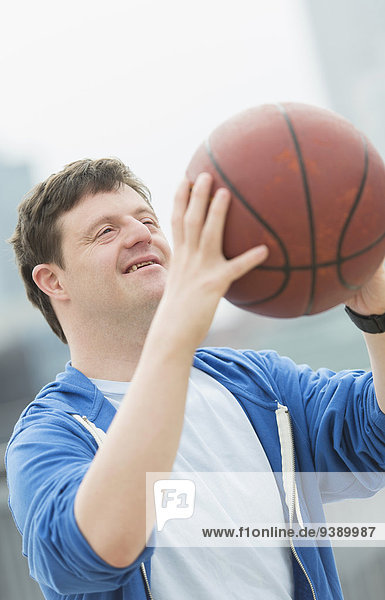 Man with down syndrome playing basketball