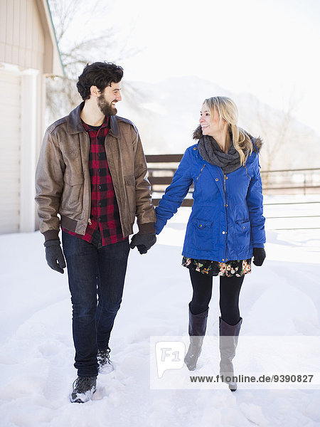 Young couple walking outdoors in winter