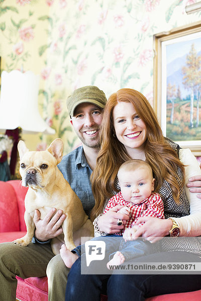 Portrait of family with one child (2-5 months) and French bulldog