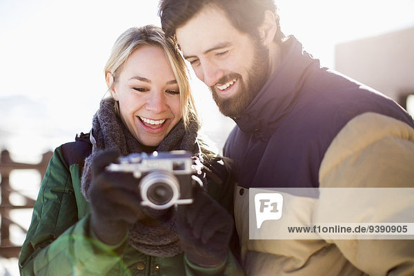 Couple looking at old-fashioned camera