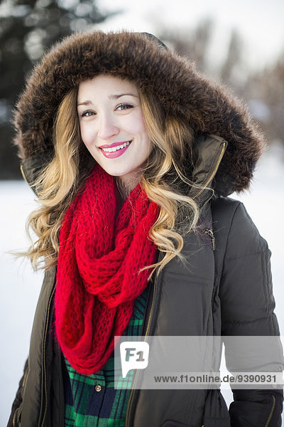 Portrait of woman wearing red scarf smiling outdoors