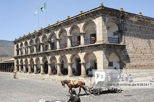 Ayuntamento  Guatemala  Central America  afternoon  Antigua  arch  architecture  central  colonial  column  downtown  facade  flags  palace  religion  sky  unesco  window  world heritage  horse  coach