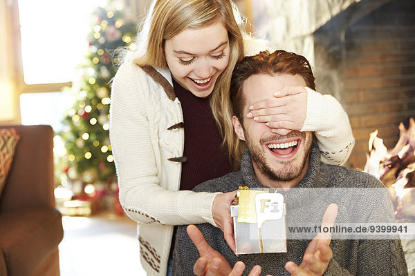 Couple exchanging gifts on Christmas