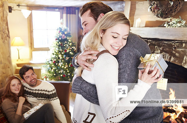 Couple exchanging gifts on Christmas