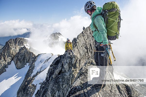 Two woman climbing on the North Ridge of Forbidden Peak in North Cascades National Park.