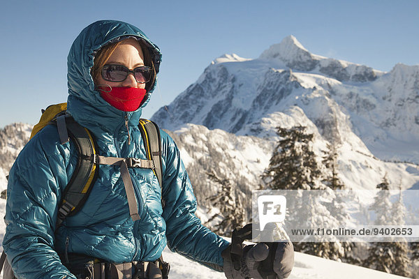 Portrait of a woman with winter clothes on while snowshoeing.