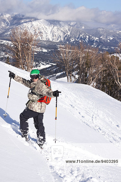 A male skier celebrates after skiing a deep powder run at Big Sky Resort in Big Sky  Montana.