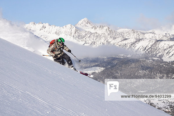 A male skier skiing untracked powder at Big Sky Resort in Big Sky  Montana.