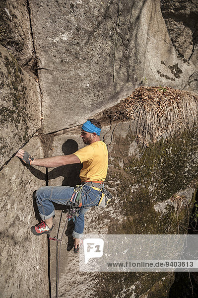 Man trad climbing a crack route in Cadarese  one of the main places in Europe for trad and crack climbing. Premia  Ossola  Italy.