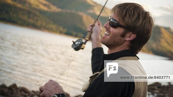 At The Edge Of Blonde Hair Carefree Casual Colorado day Durango fishing Fishing Rod Fly-Fishing Getting Away From It All Head And Shoulders Holding Horizontal Horizontal Leisure Activity mountain One Person One Young Man Only outdoors relaxation River Sh