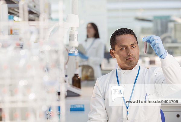 Scientist examining sample in test tube in laboratory