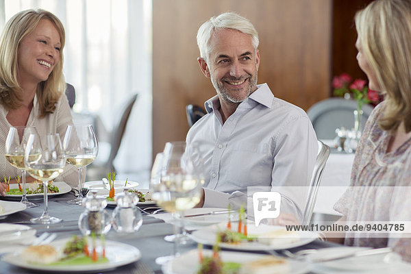 Smiling people enjoying their meal in restaurant