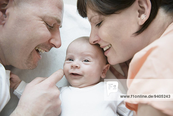 Parents playing with baby boy  smiling