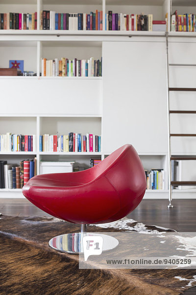 Chair in livingroom infront of book shelf