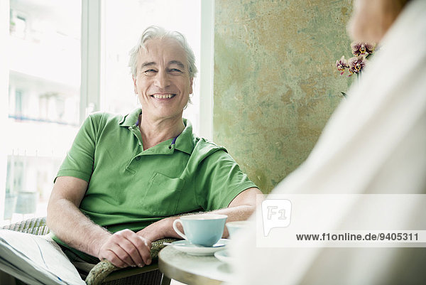 Couple having coffee together  smiling