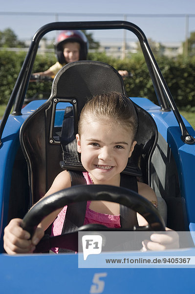 Smiling girl in vehicle on driver training area