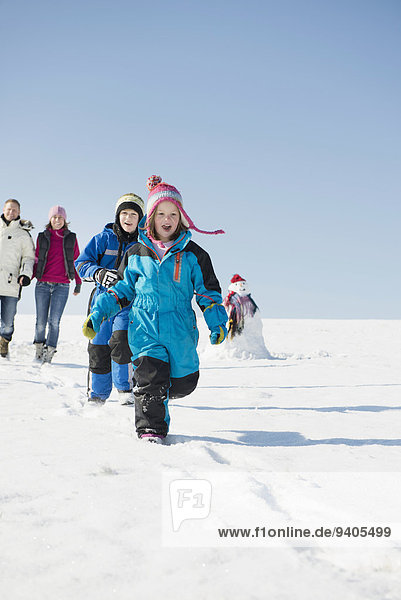 Family running in snow