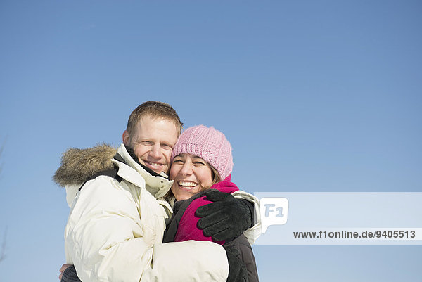 Portrait of couple in winter  smiling