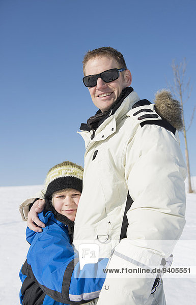 Father and son embracing  smiling